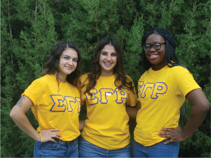3 women students wearing yellow shirts with the greek symbols for Sigma Gamma Rho